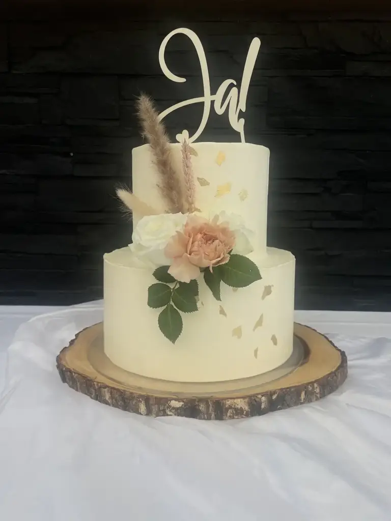Hochzeitstorte mit frischen Blumen und Cake Topper